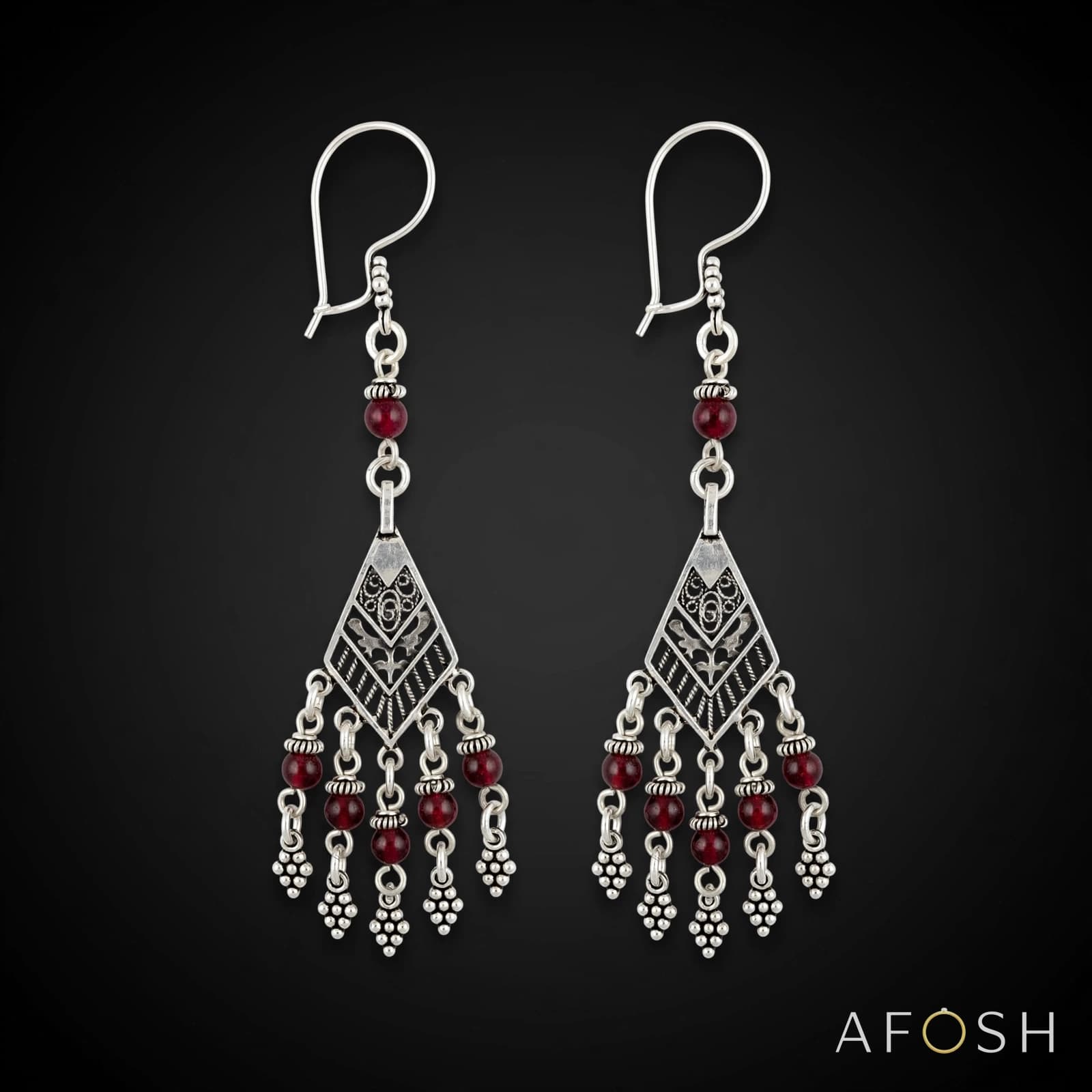 Silver earring studded with garnet stone